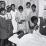 Nurse Shamburg directs group of girls in making sick bed in clinic (Arlonzia Pettway is at back left) (Image: Marion Post Wolcott, 1939)