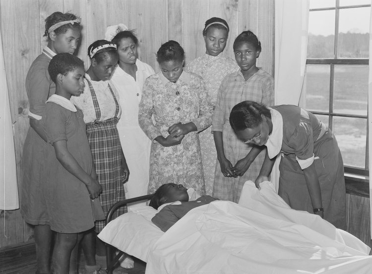 Nurse Shamburg directs a group of girls Nurse Shamburg directs a group of girls